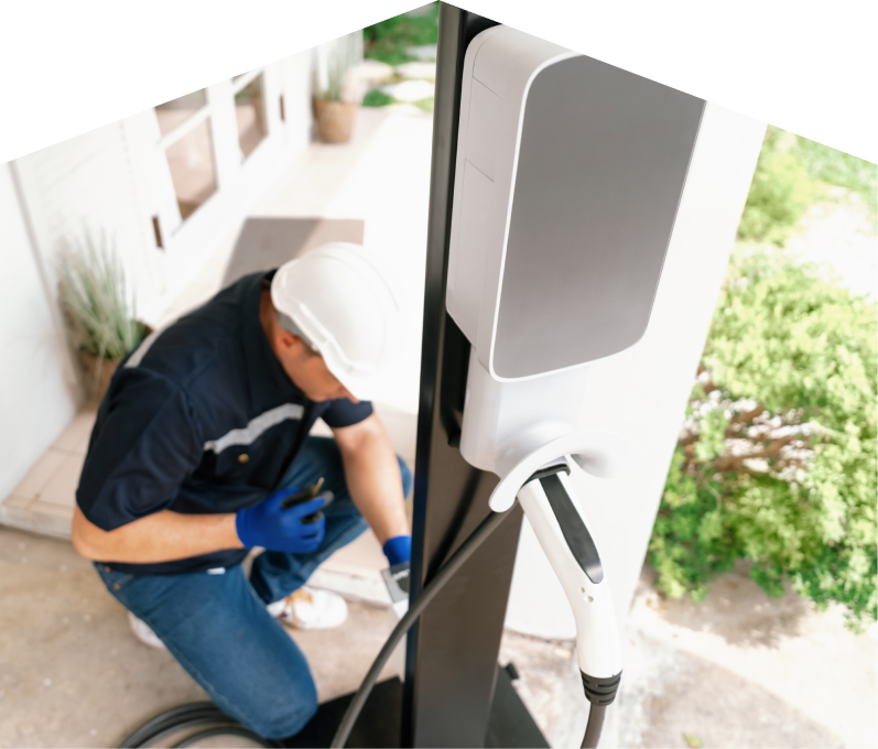 Home service electrician from Home Aire Care installing an EV charger fixed to a vertical post near a residential entryway. Home service electrician from Home Aire Care installing an EV charger fixed to a vertical post near a residential entryway.