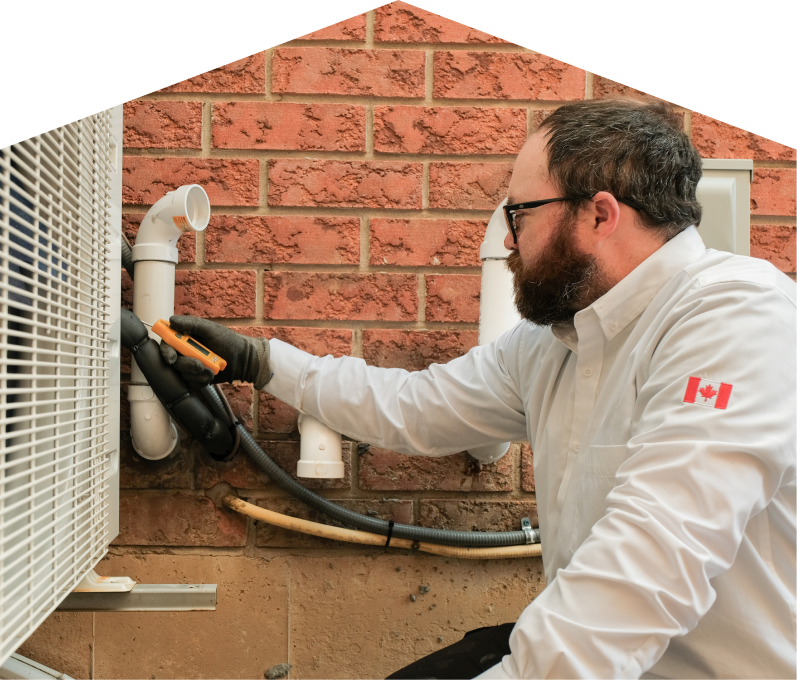 Home Aire Care HVAC specialist checking insulated piping on a heat pump unit beside a brick wall during a diagnostic service. Home Aire Care HVAC specialist checking insulated piping on a heat pump unit beside a brick wall during a diagnostic service.