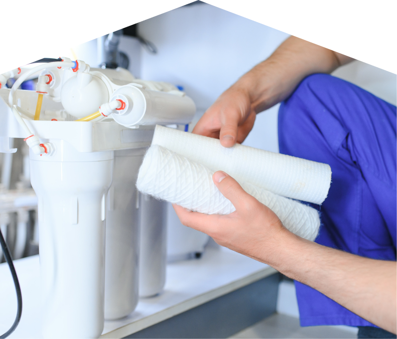 Home Aire Care water filtration specialist replacing filter cartridges on a reverse osmosis water system installed under a sink. Home Aire Care water filtration specialist replacing filter cartridges on a reverse osmosis water system installed under a sink.